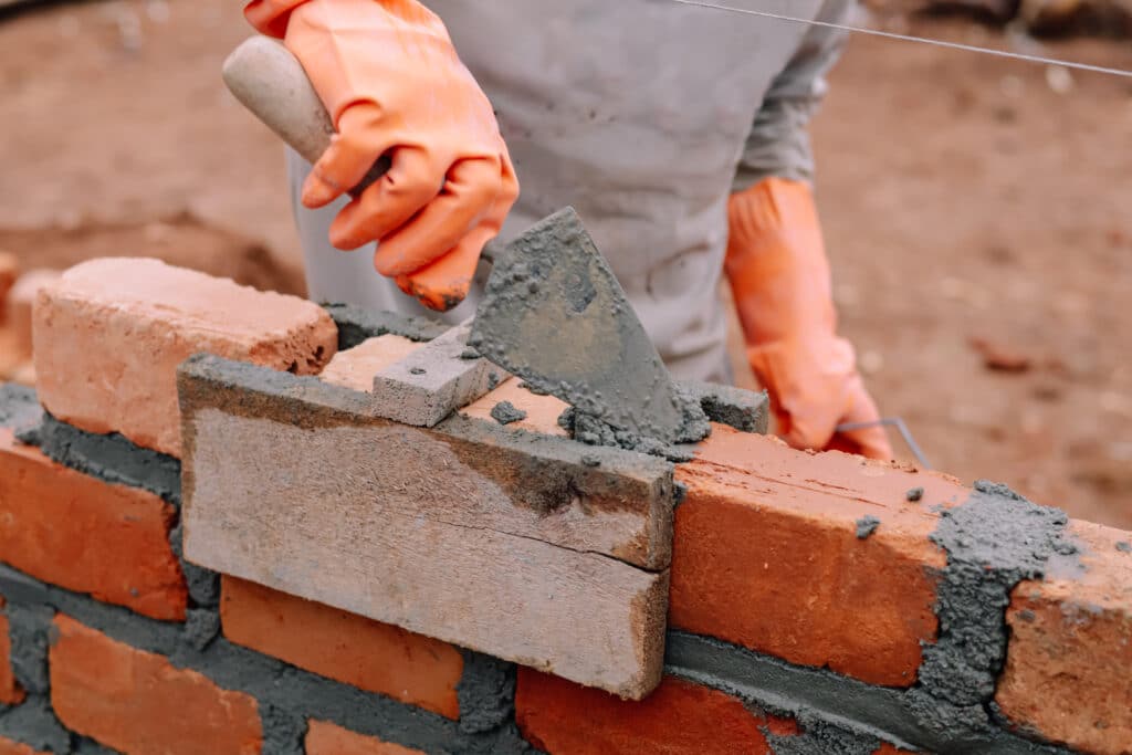 Workers are cementing bricks on a baguna with bricks in the background and shovels in hand, lampung utara, Indonesia 10 Juni 2024